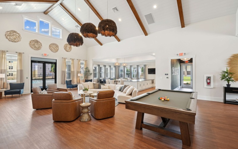 large lounge room with a pool table and seating