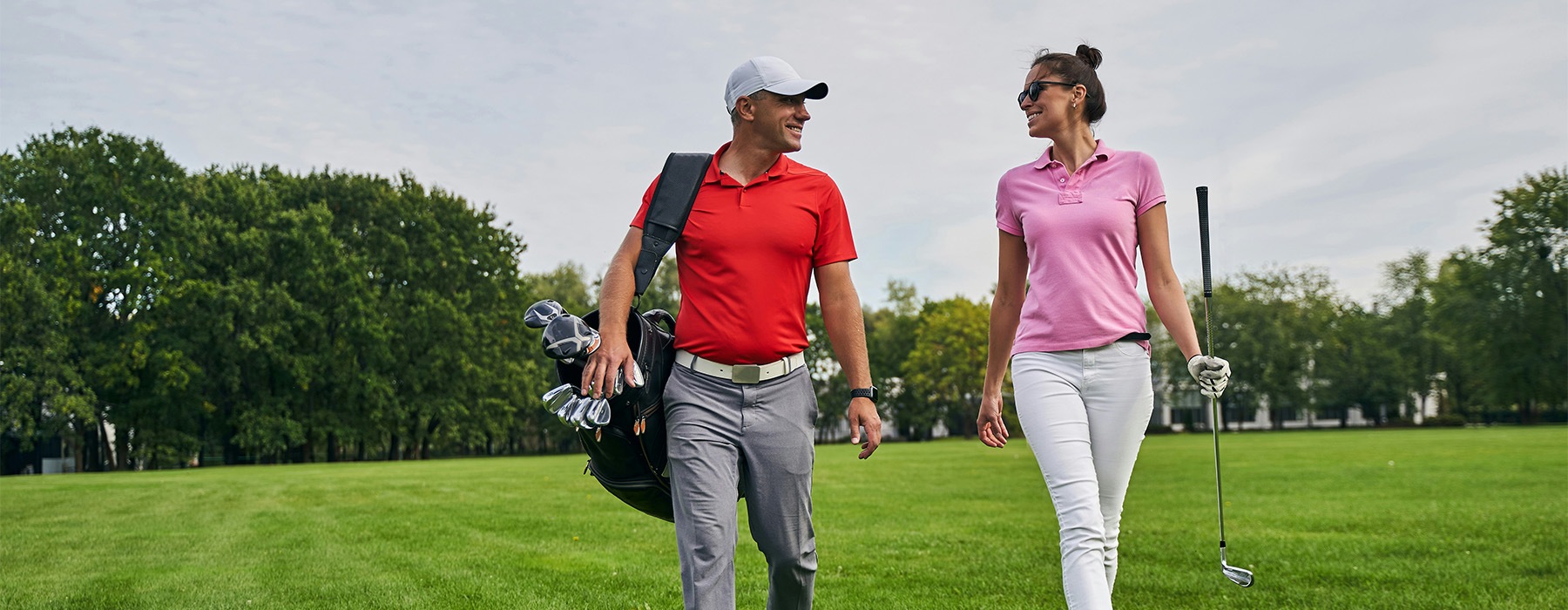 a man and a woman on a golf course